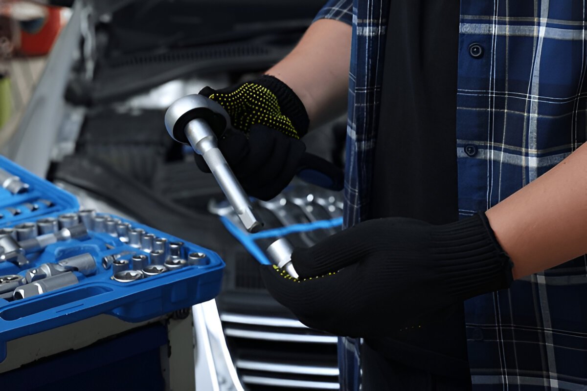 What Type of Tool Is a Torque Wrench Used For? Close-up of a torque wrench being used on a car engine bolt